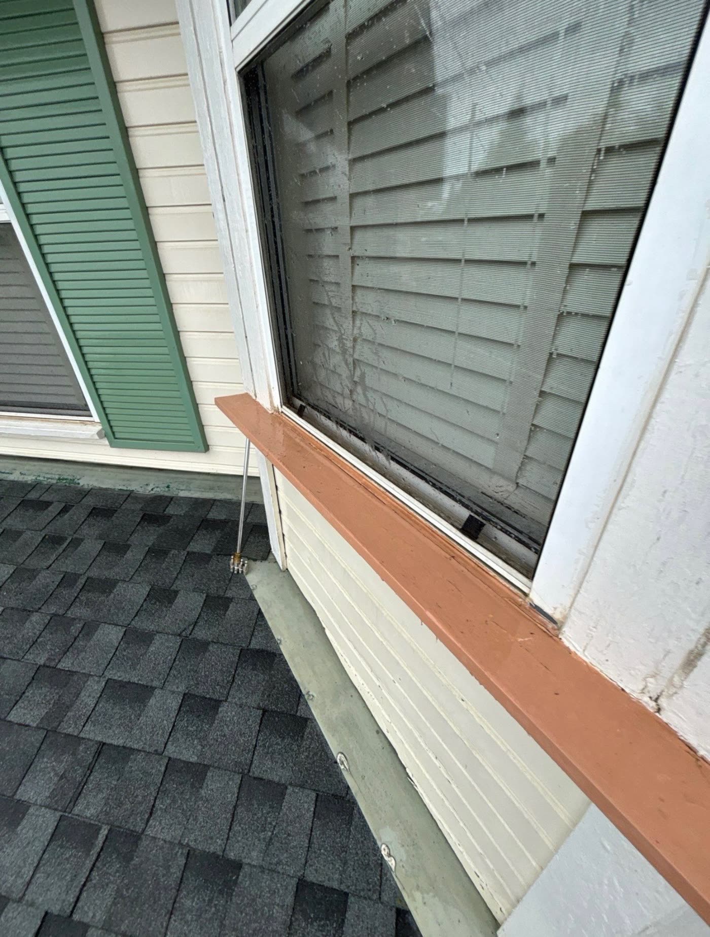 The same shingles and trim after cleaning, with the moss removed and the surfaces clear