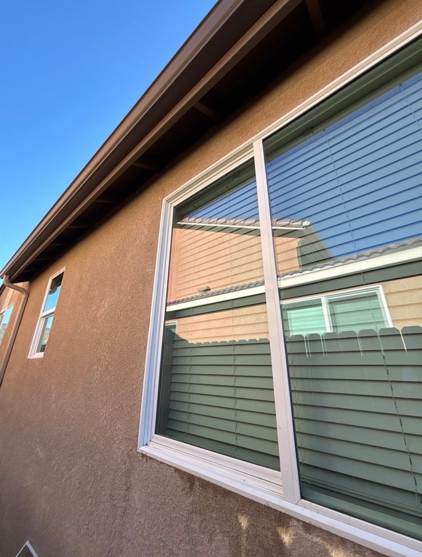 The same window after cleaning, with clear streak-free glass and a wiped frame