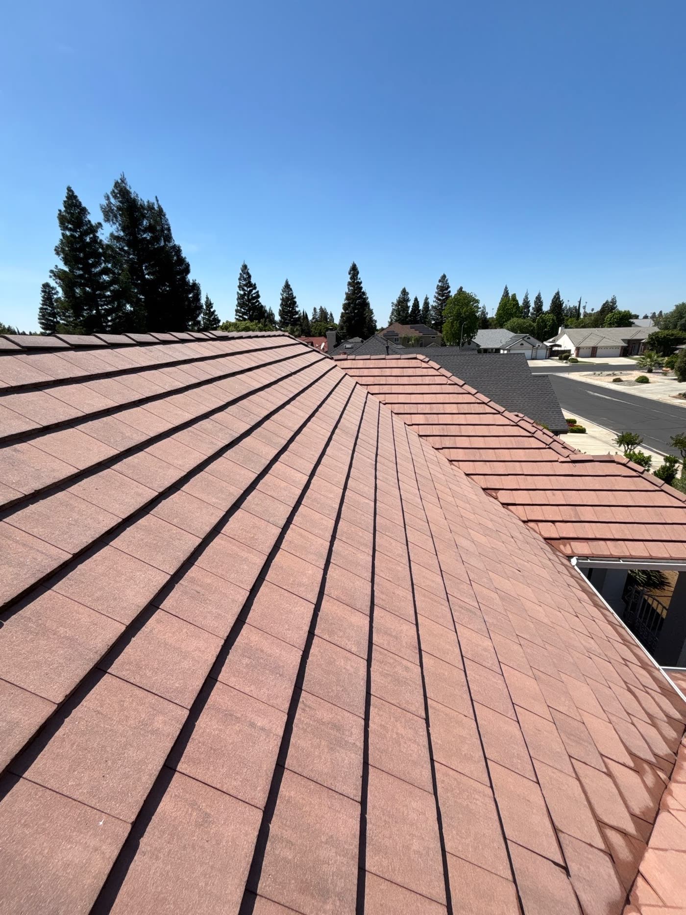 The same roof slope after soft washing, showing clean, uniform terracotta tile